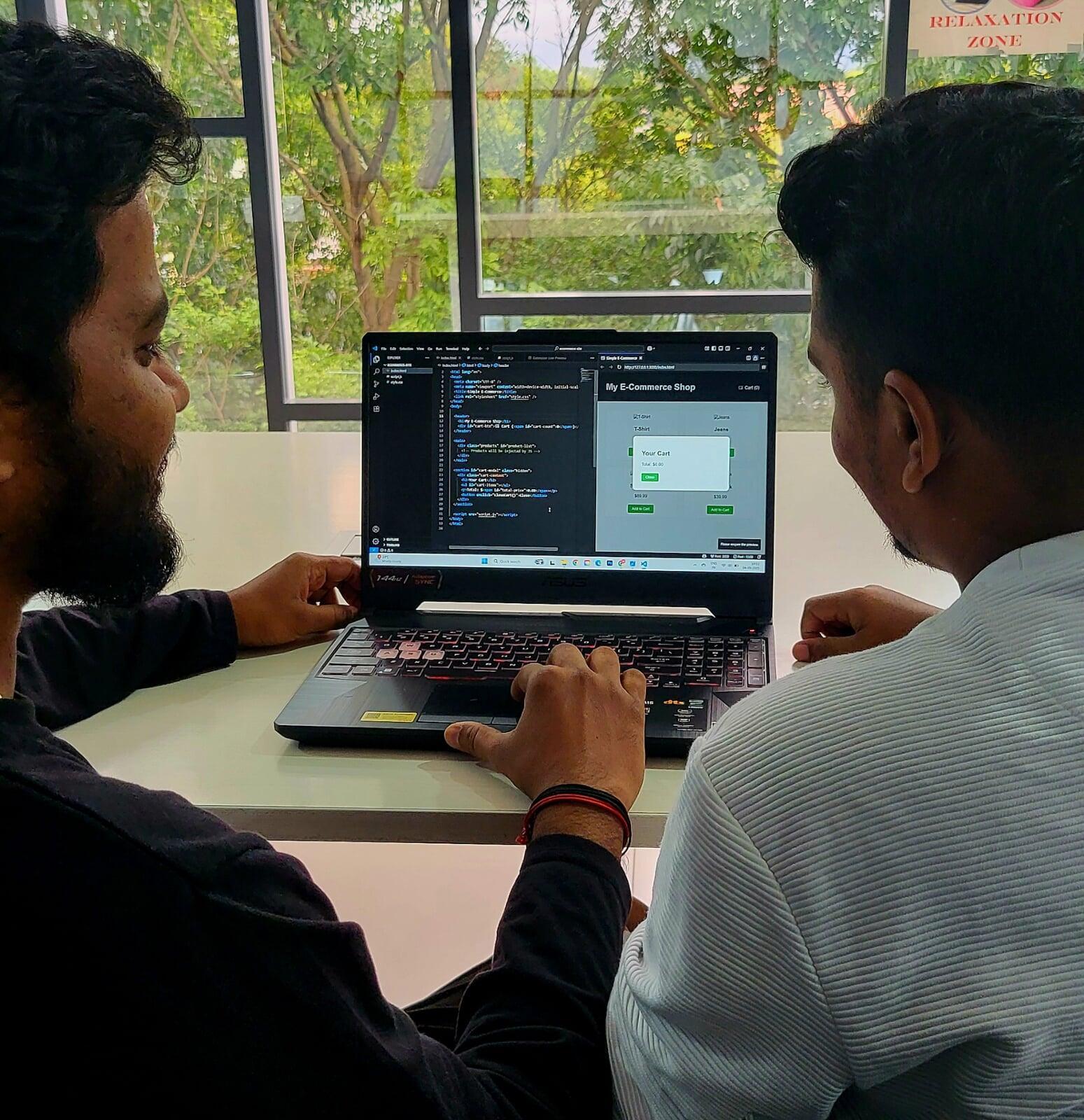 Two interns working on web development